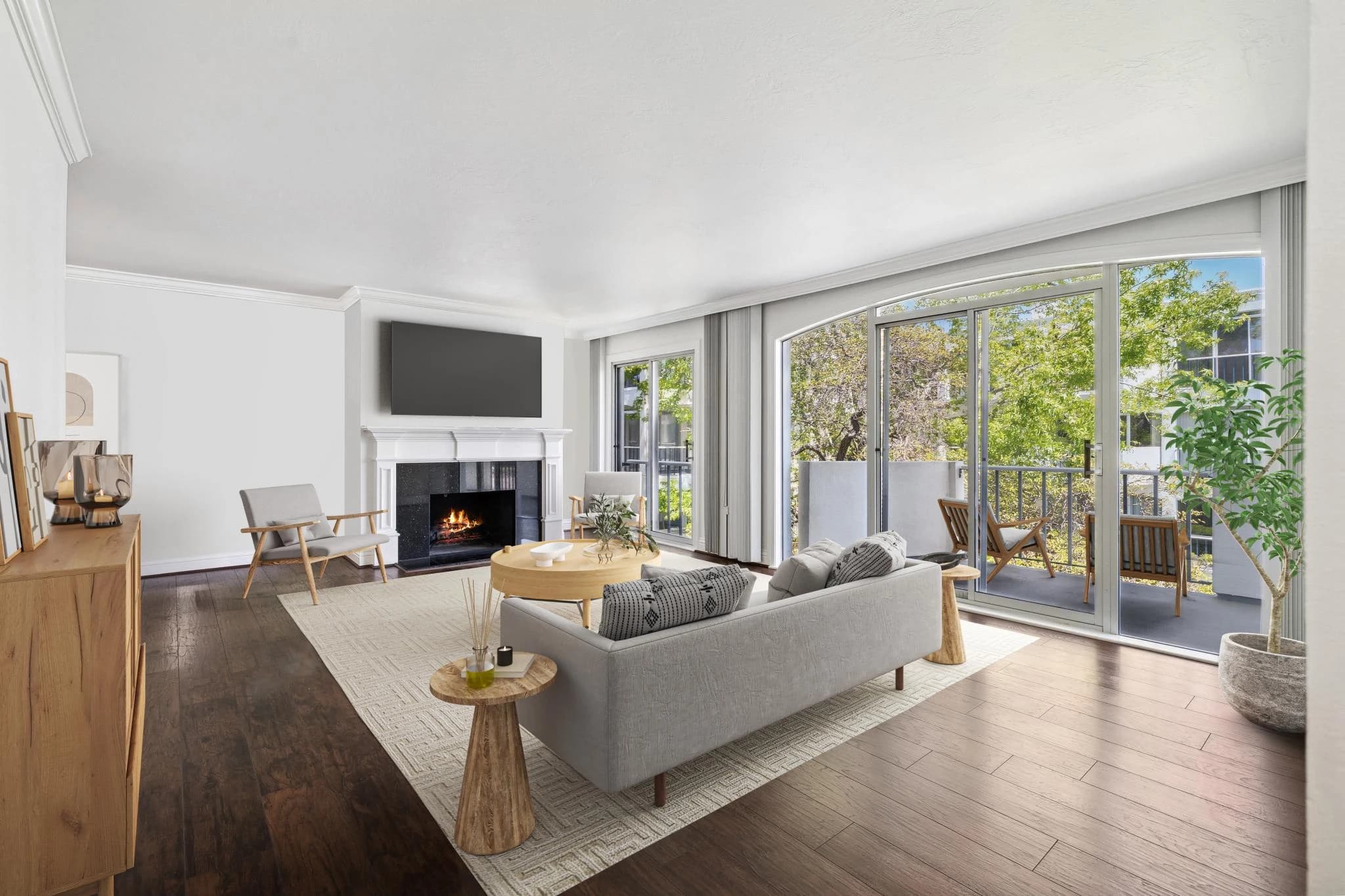 Living room at 3226 Shelter Bay Avenue with a fireplace and sliding doors to the balcony