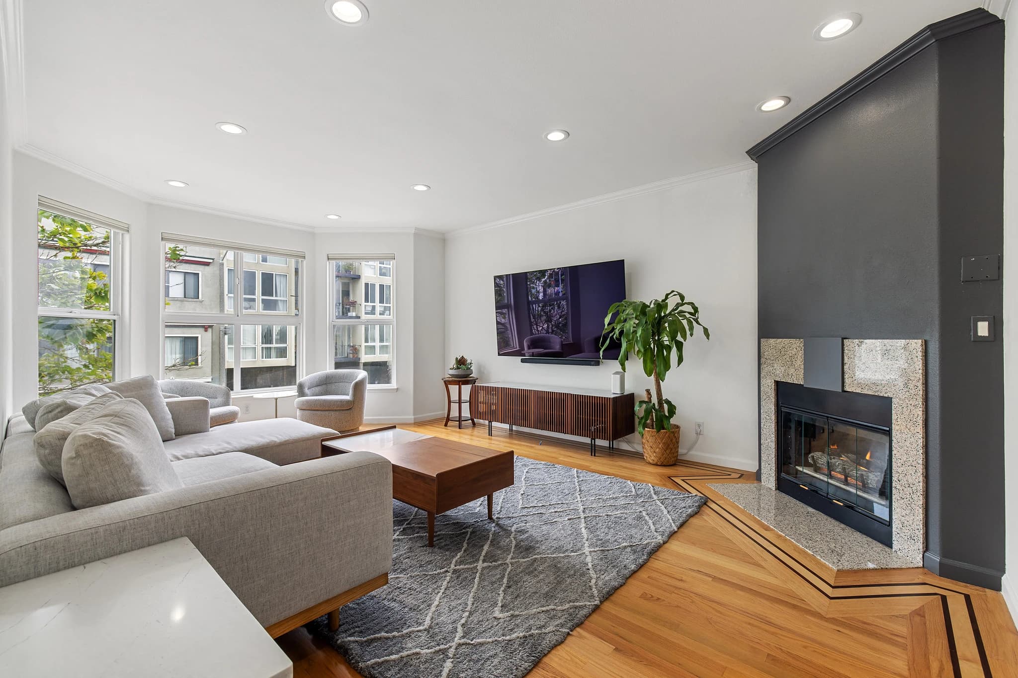 Living room at 688 25th Avenue with bay windows, wood flooring and a fireplace